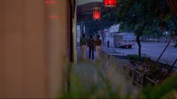 Movie still from “Saint Jack” (1979), directed by Peter Bogdanovich – A group of people walking down a sidewalk; Wide shot, High angle