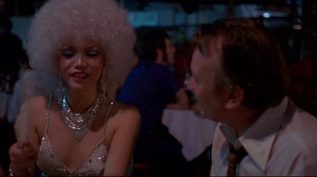 Movie still from “Saint Jack” (1979), directed by Peter Bogdanovich – A man and a woman are talking to each other in a restaurant; Close Up shot, Over the shoulder angle