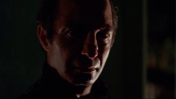Movie still from “Saint Jack” (1979), directed by Peter Bogdanovich – A person's face in the dark; Close Up shot, Low angle