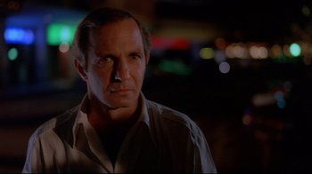 Movie still from “Saint Jack” (1979), directed by Peter Bogdanovich – A person wearing a shirt; Close Up shot, Low angle