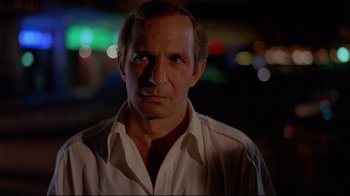 Movie still from “Saint Jack” (1979), directed by Peter Bogdanovich – A person wearing a white shirt; Close Up shot, Low angle