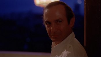 Movie still from “Saint Jack” (1979), directed by Peter Bogdanovich – A person wearing a white shirt; Close Up shot, Low angle