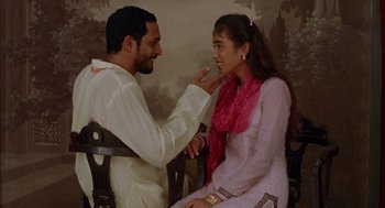 Movie still from “Salaam Bombay!” (1988), directed by Mira Nair – A man and a woman sitting on a bench; Medium shot, High angle