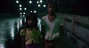 Movie still from “Salaam Bombay!” (1988), directed by Mira Nair – Two young children standing next to each other; Medium shot, High angle