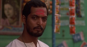 Movie still from “Salaam Bombay!” (1988), directed by Mira Nair – A person with a forehead tattoo; Close Up shot, Low angle