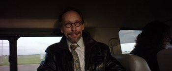 Movie still from “Salt and Fire” (2016), directed by Werner Herzog – A man in a suit and tie sitting in a car; Close Up shot, Over the shoulder angle