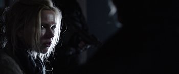 Movie still from “Salt and Fire” (2016), directed by Werner Herzog – A woman with blond hair is looking at the camera; Close Up shot, Over the shoulder angle