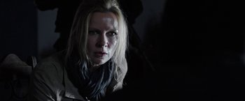 Movie still from “Salt and Fire” (2016), directed by Werner Herzog – A woman in a black scarf is looking at the camera; Close Up shot, Over the shoulder angle