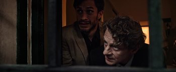 Movie still from “Salt and Fire” (2016), directed by Werner Herzog – Two men looking at a computer screen together; Close Up shot, Over the shoulder angle