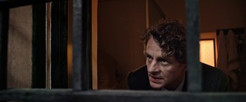 Movie still from “Salt and Fire” (2016), directed by Werner Herzog – A person looking out a window; Close Up shot, Over the shoulder angle