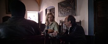 Movie still from “Salt and Fire” (2016), directed by Werner Herzog – A man and a woman are sitting at a table; Medium shot, Over the shoulder angle