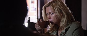 Movie still from “Salt and Fire” (2016), directed by Werner Herzog – A woman holding a coffee cup in her hand; Close Up shot, Over the shoulder angle