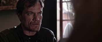 Movie still from “Salt and Fire” (2016), directed by Werner Herzog – A person wearing a black shirt; Close Up shot, Over the shoulder angle