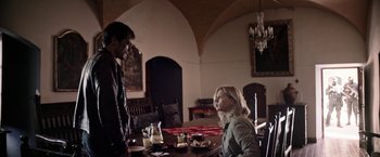 Movie still from “Salt and Fire” (2016), directed by Werner Herzog – A man and a woman sitting at a dining room table; Medium shot, Over the shoulder angle