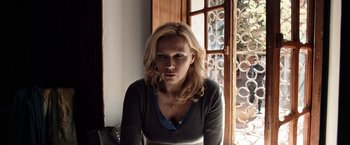 Movie still from “Salt and Fire” (2016), directed by Werner Herzog – A woman sitting in front of an open window; Close Up shot, Over the shoulder angle