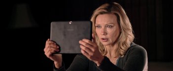 Movie still from “Salt and Fire” (2016), directed by Werner Herzog – A woman holding an ipad in front of her face; Close Up shot, Over the shoulder angle