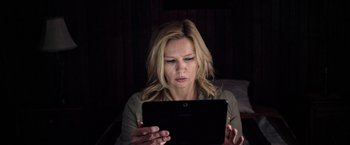 Movie still from “Salt and Fire” (2016), directed by Werner Herzog – A woman looking at a tablet computer in a dark room; Close Up shot, Low angle