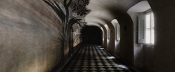Movie still from “Salt and Fire” (2016), directed by Werner Herzog – A black and white checkerboard hallway with a mural on the wall; Extreme Wide shot, High angle