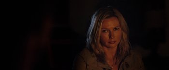 Movie still from “Salt and Fire” (2016), directed by Werner Herzog – A beautiful woman with blonde hair in a dark room; Close Up shot, Over the shoulder angle