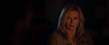 Movie still from “Salt and Fire” (2016), directed by Werner Herzog – A woman is standing in a dark room; Close Up shot, Over the shoulder angle