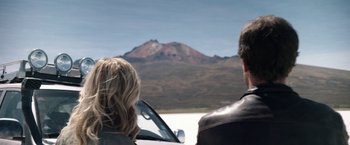 Movie still from “Salt and Fire” (2016), directed by Werner Herzog – A man and a woman looking out at a mountain; Medium shot, Over the shoulder angle