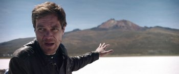 Movie still from “Salt and Fire” (2016), directed by Werner Herzog – A man in a leather jacket is pointing to the sky; Close Up shot, Low angle