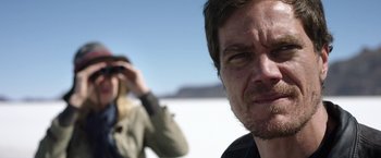 Movie still from “Salt and Fire” (2016), directed by Werner Herzog – A man and a woman standing next to each other in the desert; Close Up shot, Low angle