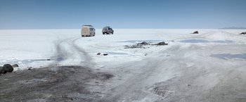 Movie still from “Salt and Fire” (2016), directed by Werner Herzog – A couple of cars parked on top of a snow covered field; Extreme Wide shot, High angle
