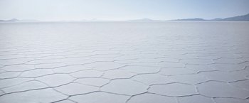 Movie still from “Salt and Fire” (2016), directed by Werner Herzog – A view of a large expanse of water with a mountain in the background; Extreme Wide shot, High angle