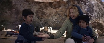 Movie still from “Salt and Fire” (2016), directed by Werner Herzog – A woman and a boy holding hands in a cave; Medium shot, Over the shoulder angle