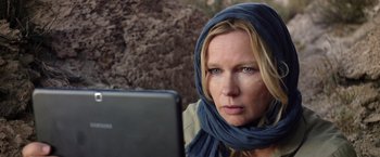 Movie still from “Salt and Fire” (2016), directed by Werner Herzog – A woman wearing a headscarf looking at a computer screen; Close Up shot, Over the shoulder angle