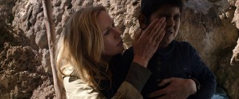 Movie still from “Salt and Fire” (2016), directed by Werner Herzog – A woman holding her hands to her chest; Close Up shot, Over the shoulder angle