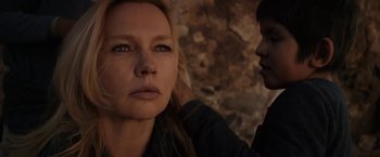 Movie still from “Salt and Fire” (2016), directed by Werner Herzog – A woman looking at the camera while a man stands next to her; Close Up shot, Over the shoulder angle