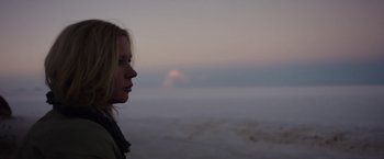 Movie still from “Salt and Fire” (2016), directed by Werner Herzog – A woman standing on the beach at sunset; Close Up shot, Low angle