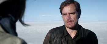 Movie still from “Salt and Fire” (2016), directed by Werner Herzog – A person wearing a leather jacket; Close Up shot, Over the shoulder angle