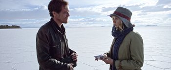 Movie still from “Salt and Fire” (2016), directed by Werner Herzog – A man and a woman are standing in the desert; Medium shot, Over the shoulder angle
