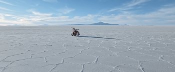 Movie still from “Salt and Fire” (2016), directed by Werner Herzog – A motorcycle parked on top of an expanse of snow; Extreme Wide shot, High angle