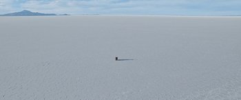 Movie still from “Salt and Fire” (2016), directed by Werner Herzog – An object sitting in the middle of an expanse of snow; Extreme Wide shot, High angle