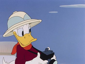Movie still from “Saludos Amigos” (1942), directed by Jack Kinney – A painting of a duck wearing a hat and holding a steering wheel; Close Up shot, Low angle