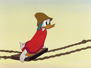Movie still from “Saludos Amigos” (1942), directed by Jack Kinney – A cartoon of a duck riding on a sled; Wide shot, Low angle