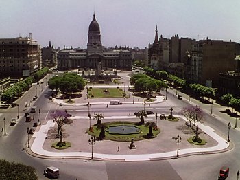 Movie still from “Saludos Amigos” (1942), directed by Jack Kinney – An aerial view of a city with a large building in the background; Extreme Wide shot, High angle
