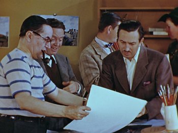 Movie still from “Saludos Amigos” (1942), directed by Jack Kinney – A group of men looking at a sheet of paper; Medium shot, Over the shoulder angle