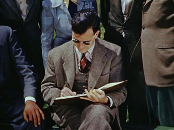 Movie still from “Saludos Amigos” (1942), directed by Jack Kinney – A man in a suit writing on a notebook; Medium shot, High angle