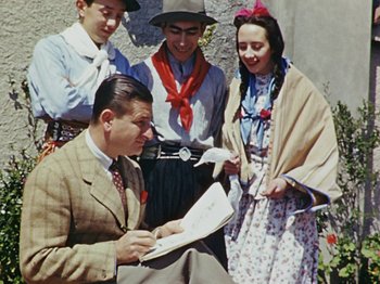 Movie still from “Saludos Amigos” (1942), directed by Jack Kinney – An old photo of a group of people looking at a map; Medium shot, High angle