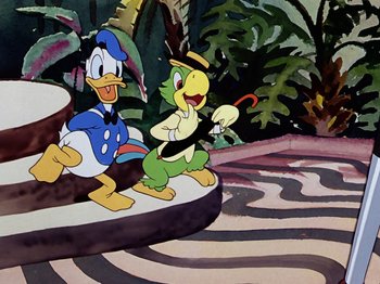 Movie still from “Saludos Amigos” (1942), directed by Jack Kinney – A painting of a duck and a bird on a platform in a park; Wide shot, High angle