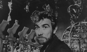 Movie still from “Salut les Cubains” (1963), directed by Agnès Varda – Black and white photograph of a bearded man in front of a bunch of crosses; Close Up shot, Low angle