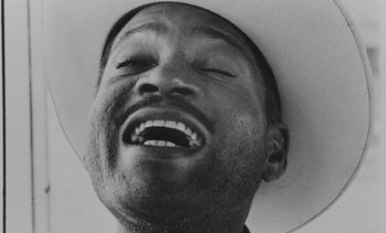 Movie still from “Salut les Cubains” (1963), directed by Agnès Varda – A black and white photo of a man with a hat; Extreme Close Up shot, Low angle