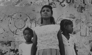 Movie still from “Salut les Cubains” (1963), directed by Agnès Varda – A black and white photo of a woman and two young girls; Medium shot, Low angle