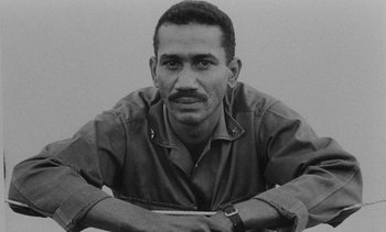 Movie still from “Salut les Cubains” (1963), directed by Agnès Varda – Black and white photograph of a man in a military uniform; Close Up shot, Low angle