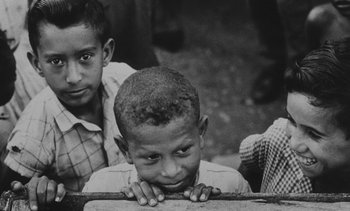 Movie still from “Salut les Cubains” (1963), directed by Agnès Varda – A black and white photo of three boys; Close Up shot, High angle